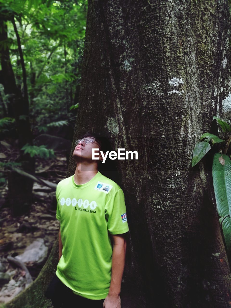 FULL LENGTH OF BOY STANDING IN FOREST