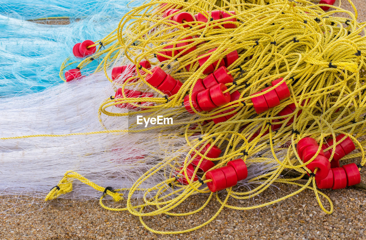 High angle view of fishing nets on sand