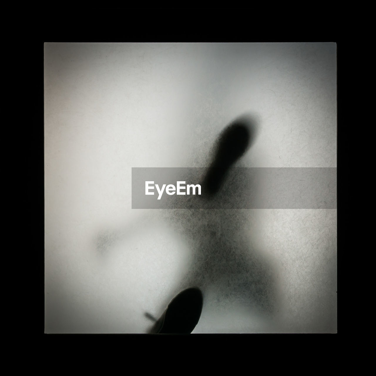 Directly below shot of person shadow walking on glass staircase