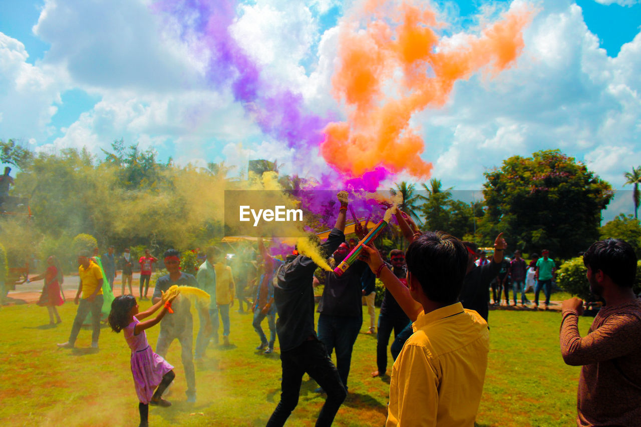 People celebrating holi at park