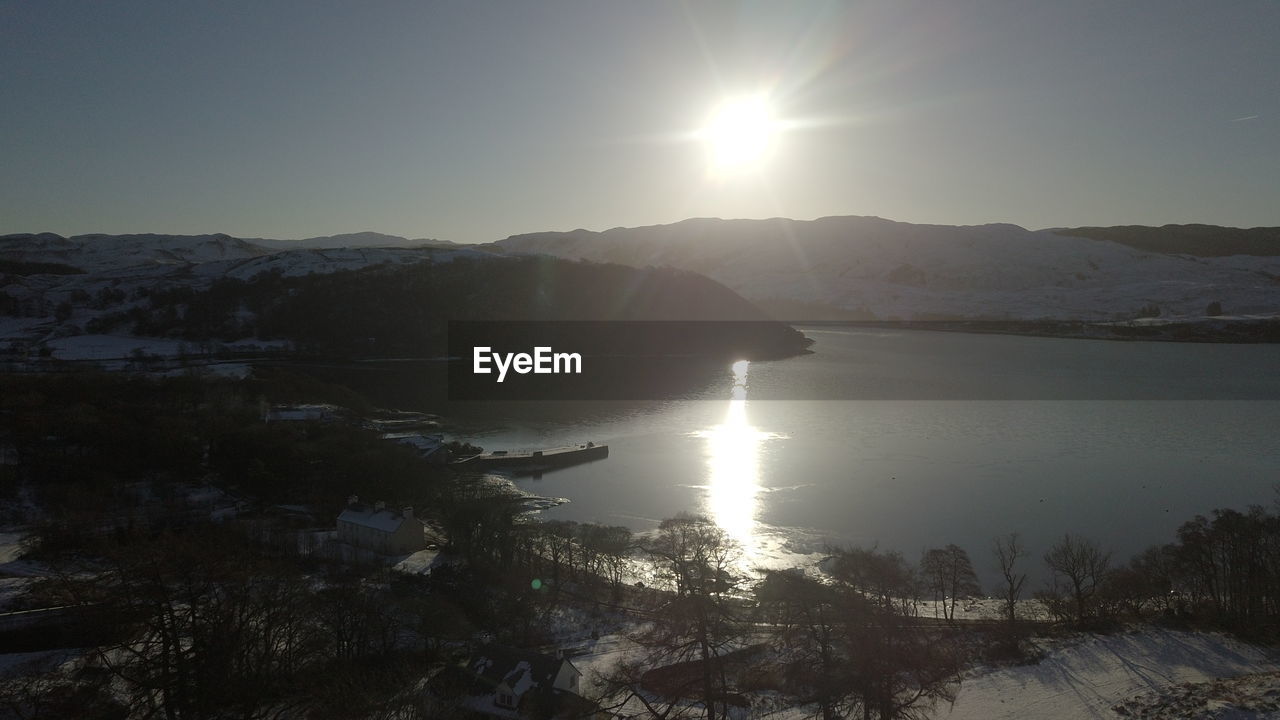 Scenic view of lake against sky during winter