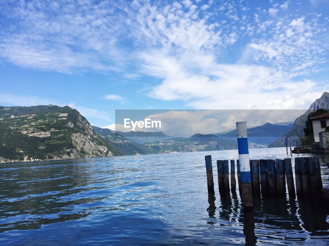 Scenic view of lake and mountains against blue sky