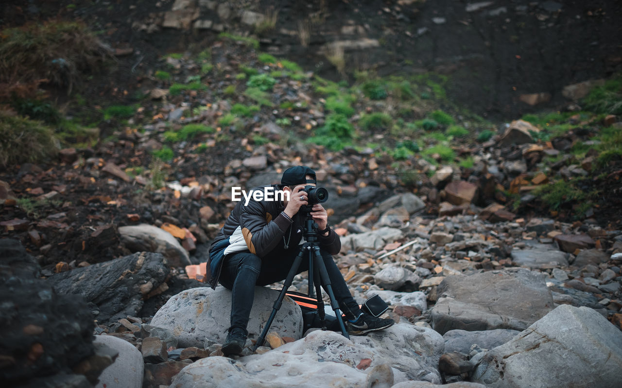 Male photographer on stones