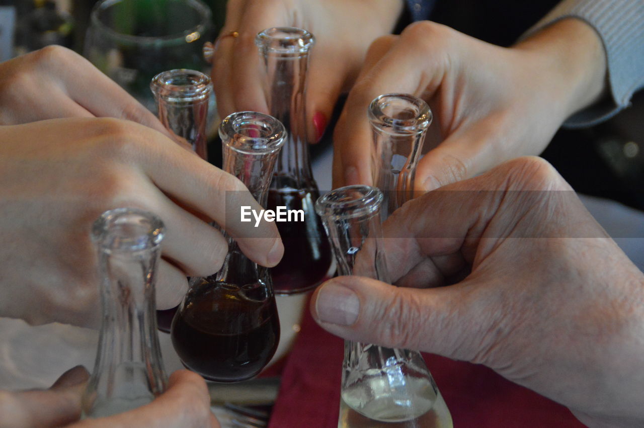 Close-up of hands toasting alcohol