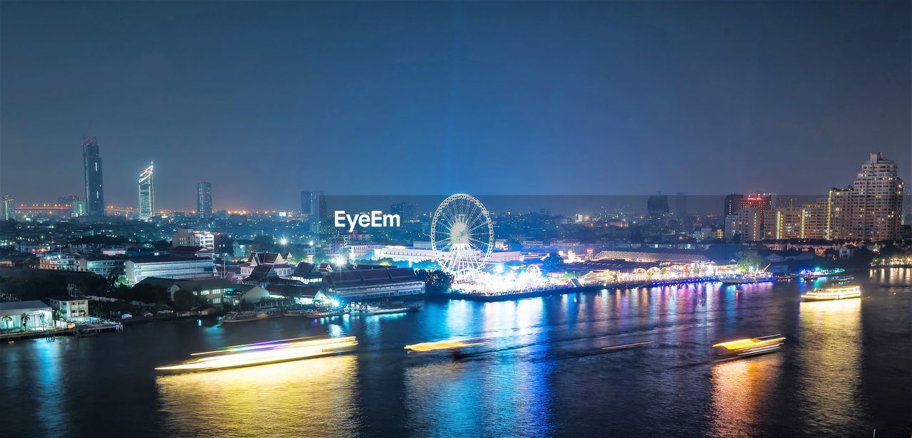 ILLUMINATED BUILDINGS AT WATERFRONT