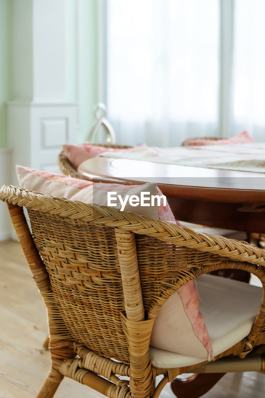 basket, indoors, chair, wicker, seat, table, furniture, no people, window, room, home interior, day, container, domestic room, wood, absence, domestic life, focus on foreground