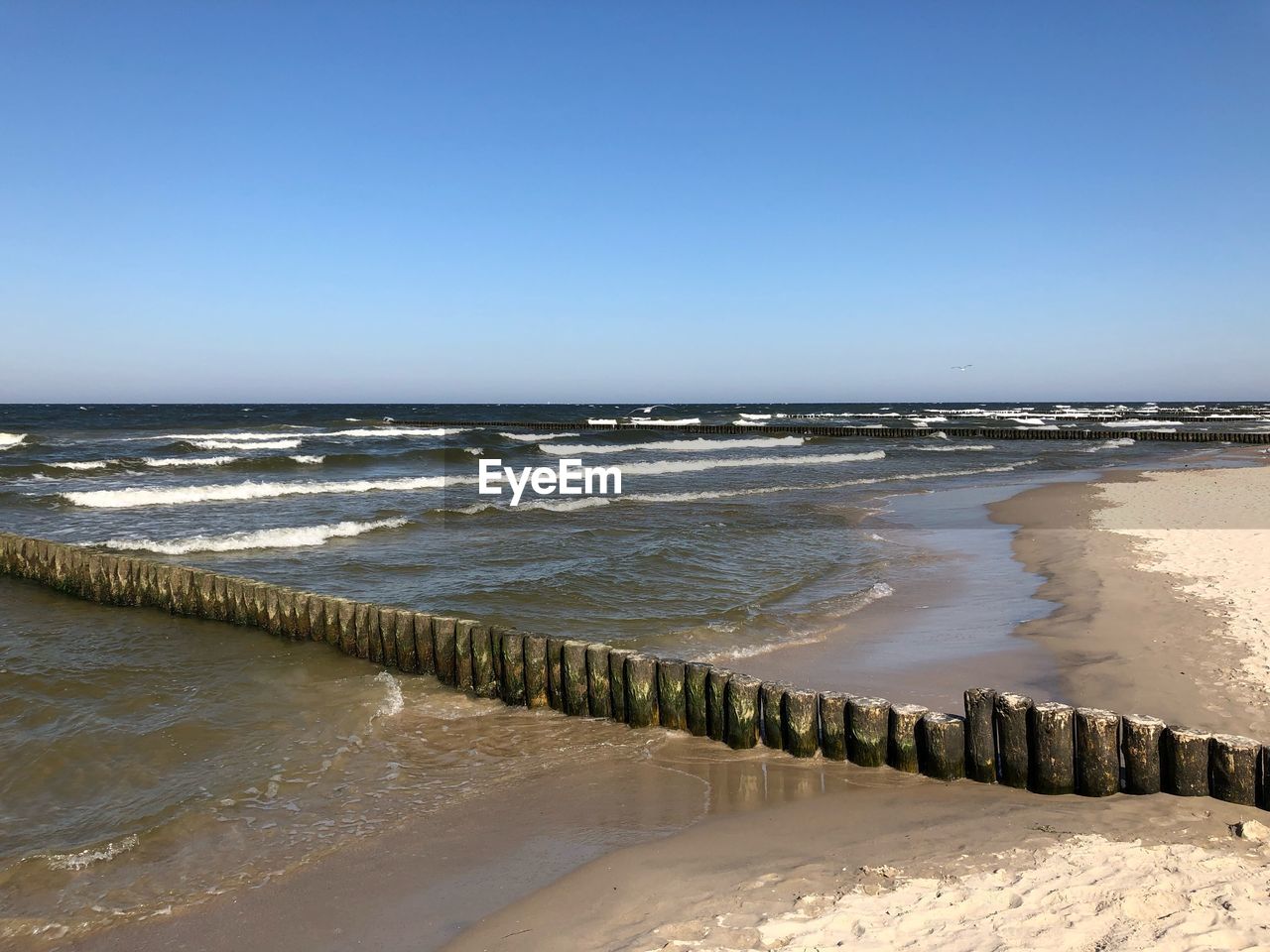 SCENIC VIEW OF BEACH AGAINST CLEAR SKY