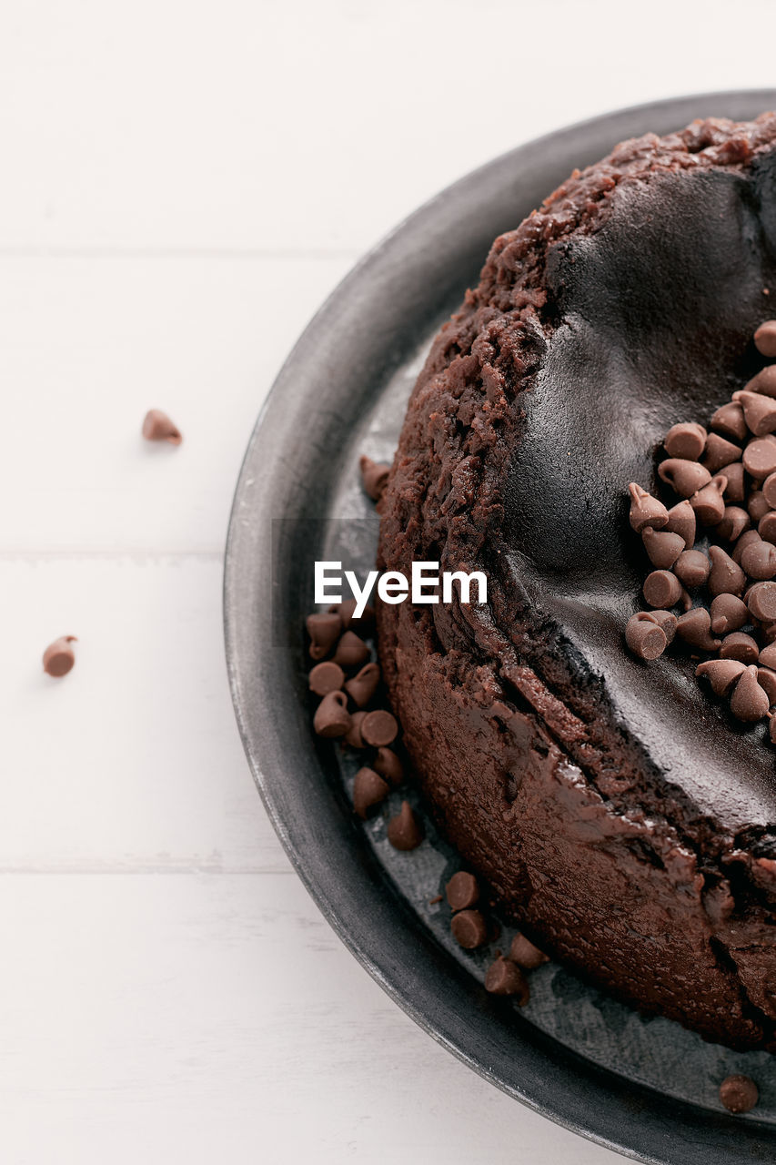 Overhead view of a chocolate basque burnt cheesecake with chocolate chips