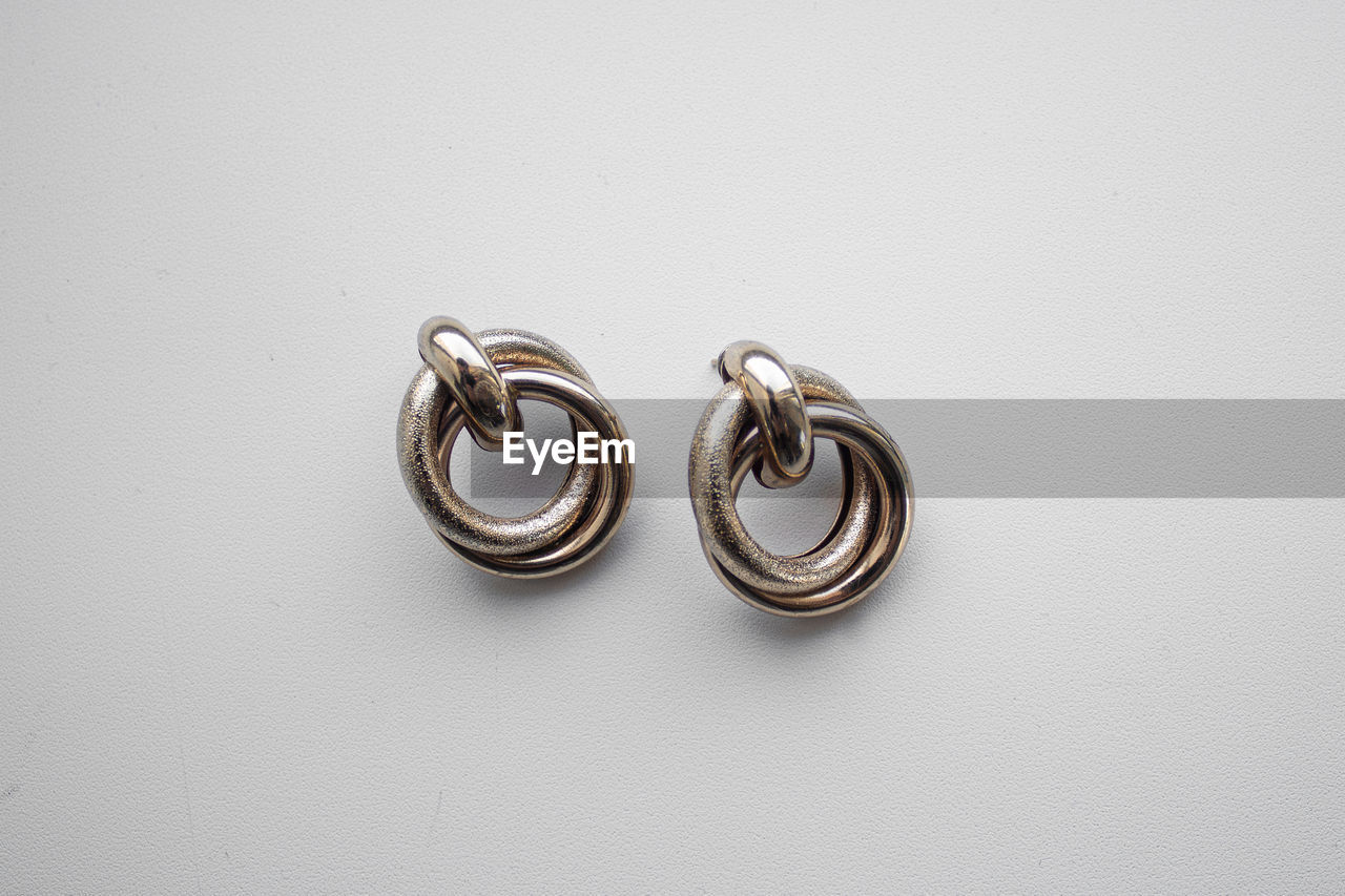 Close-up of earrings against white background