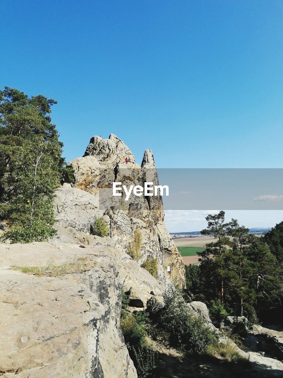 sky, rock, nature, plant, tree, scenics - nature, clear sky, beauty in nature, land, mountain, sea, blue, vacation, travel destinations, tranquility, environment, cliff, no people, travel, landscape, day, sunny, rock formation, tranquil scene, non-urban scene, outdoors, coast, water, sunlight, terrain, adventure, geology, tourism, pinaceae, coniferous tree, pine tree, mountain range, idyllic