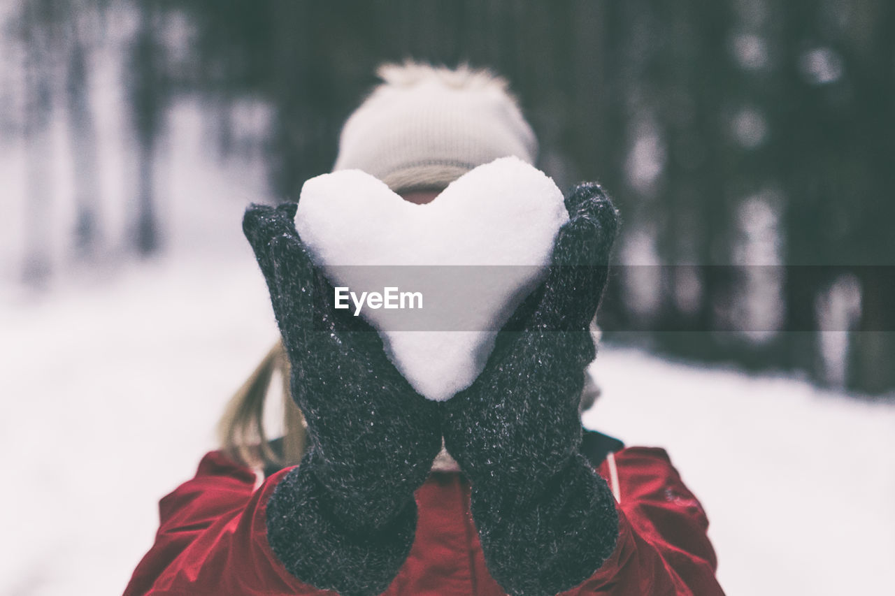 Close-up of woman holding snow