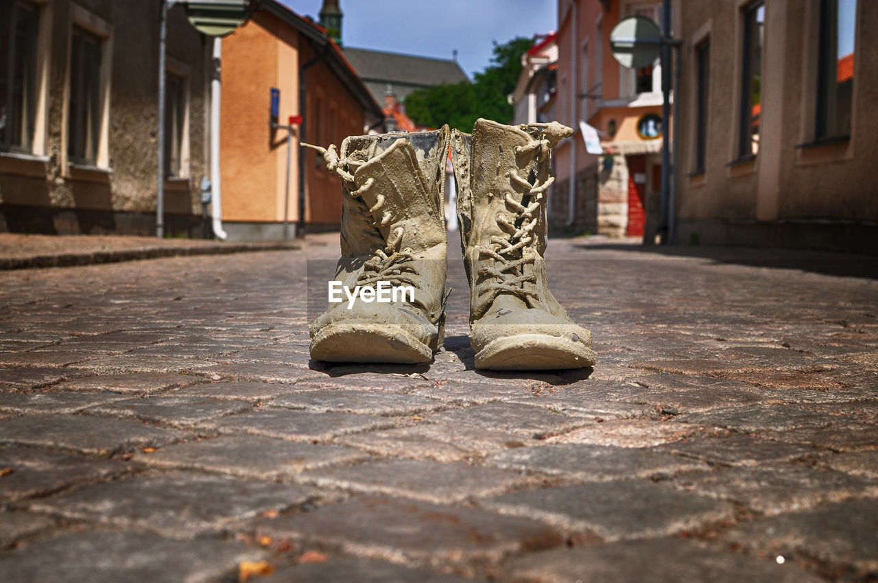 Muddy boots on street