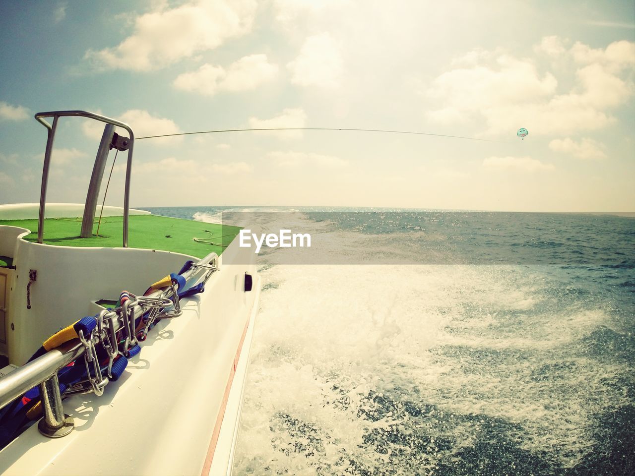 Cropped image of boat sailing on sea against sky