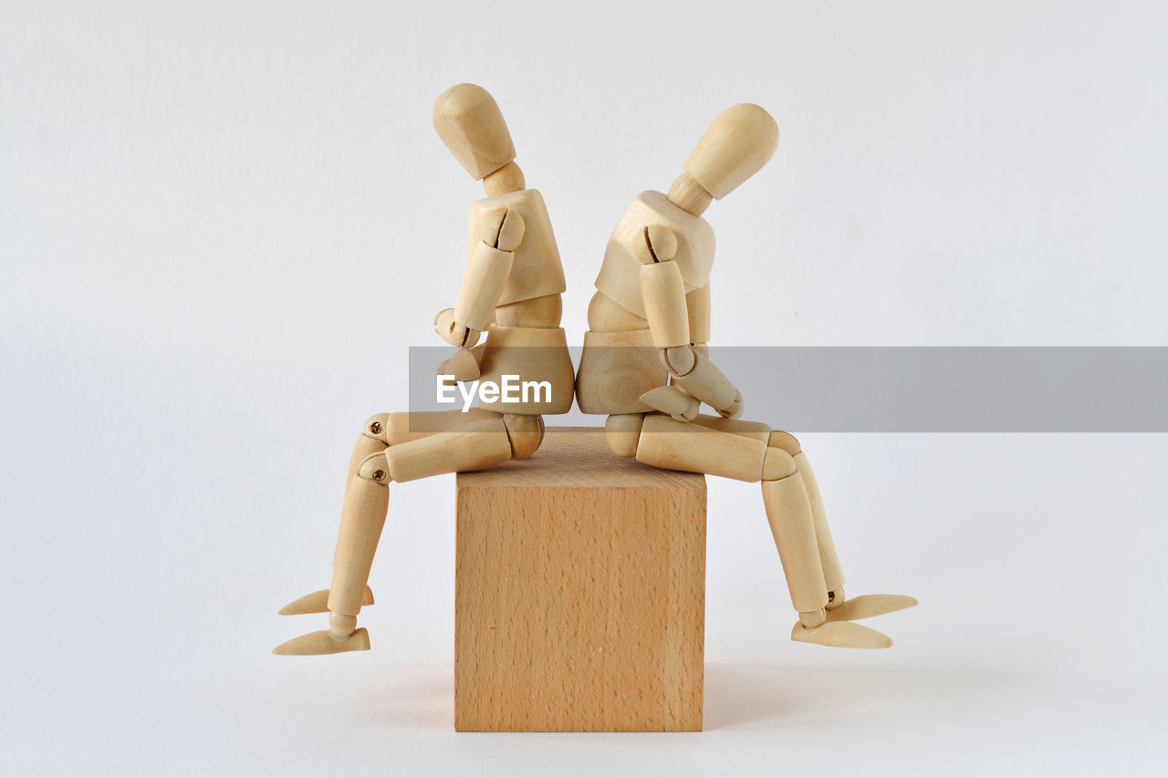 toy, human representation, studio shot, wood, indoors, sculpture, figurine, representation, white background, no people, male likeness, cut out, business, creativity