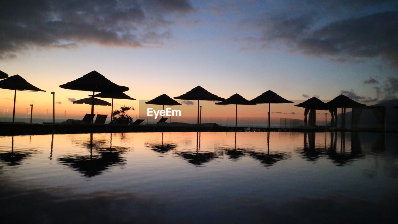 Tourist resort swimming pool at sunset