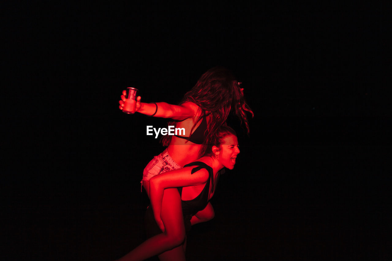 Women enjoying at lake at night