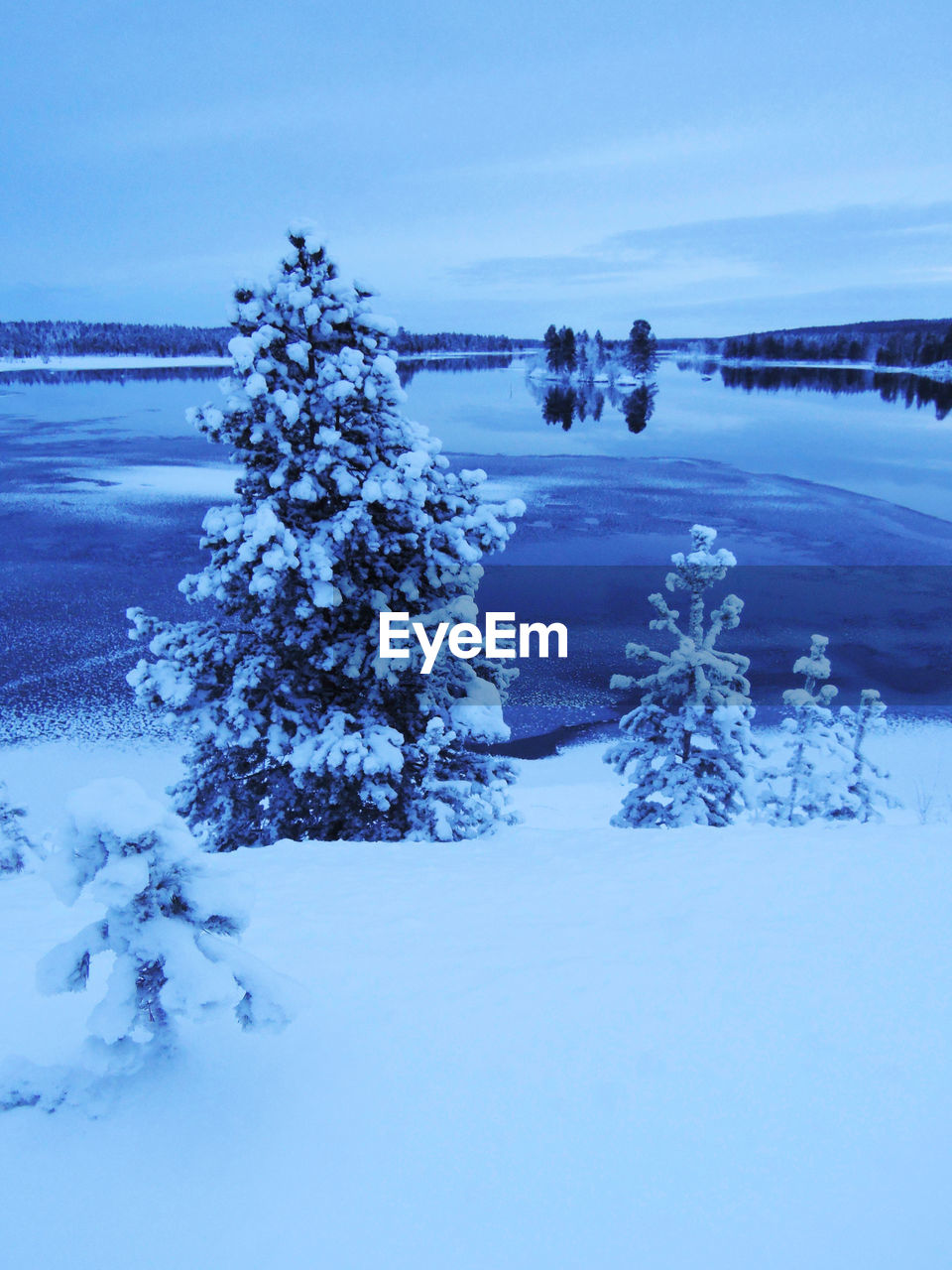 Scenic view of frozen lake against sky during winter