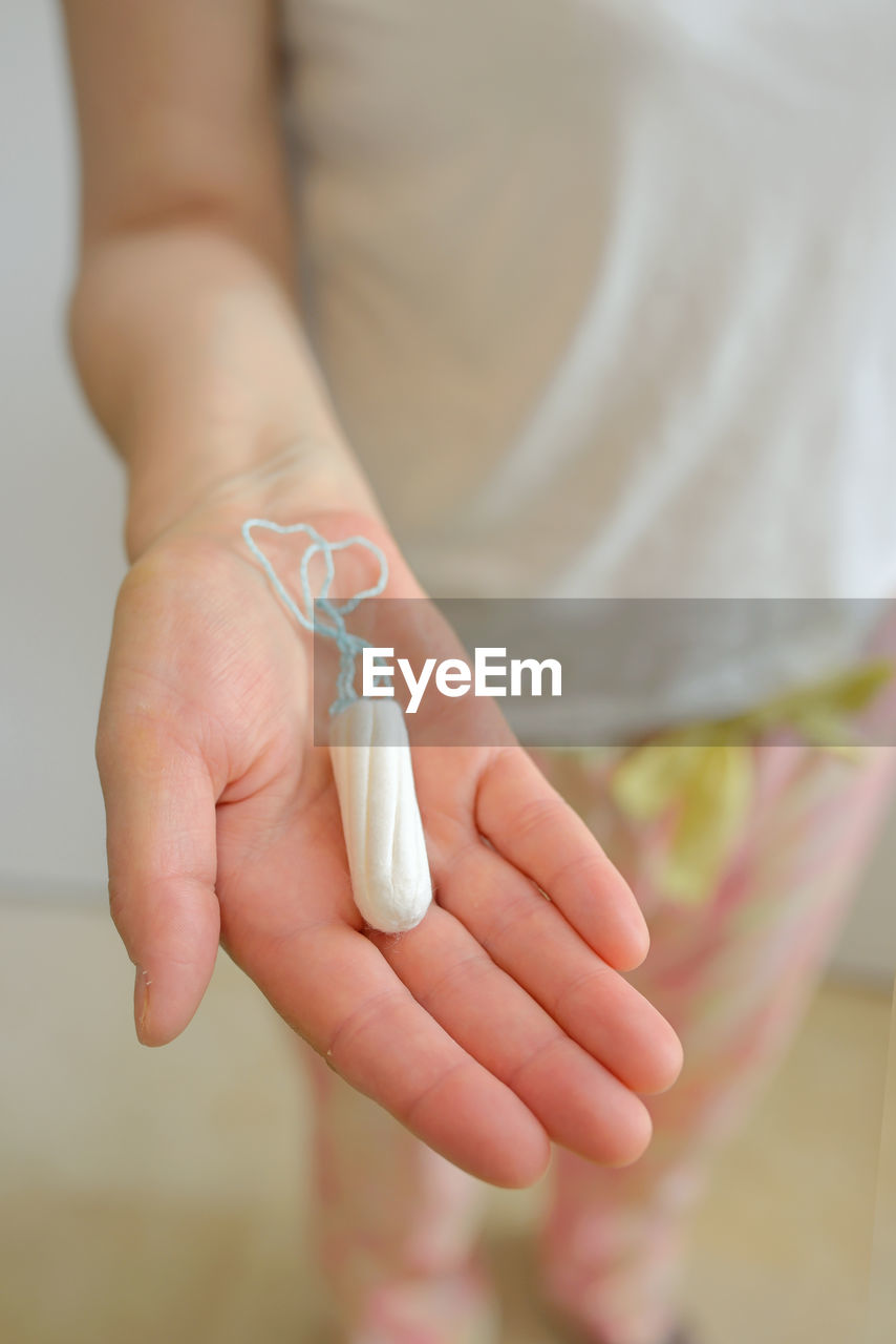 Close-up of woman hand holding tampon