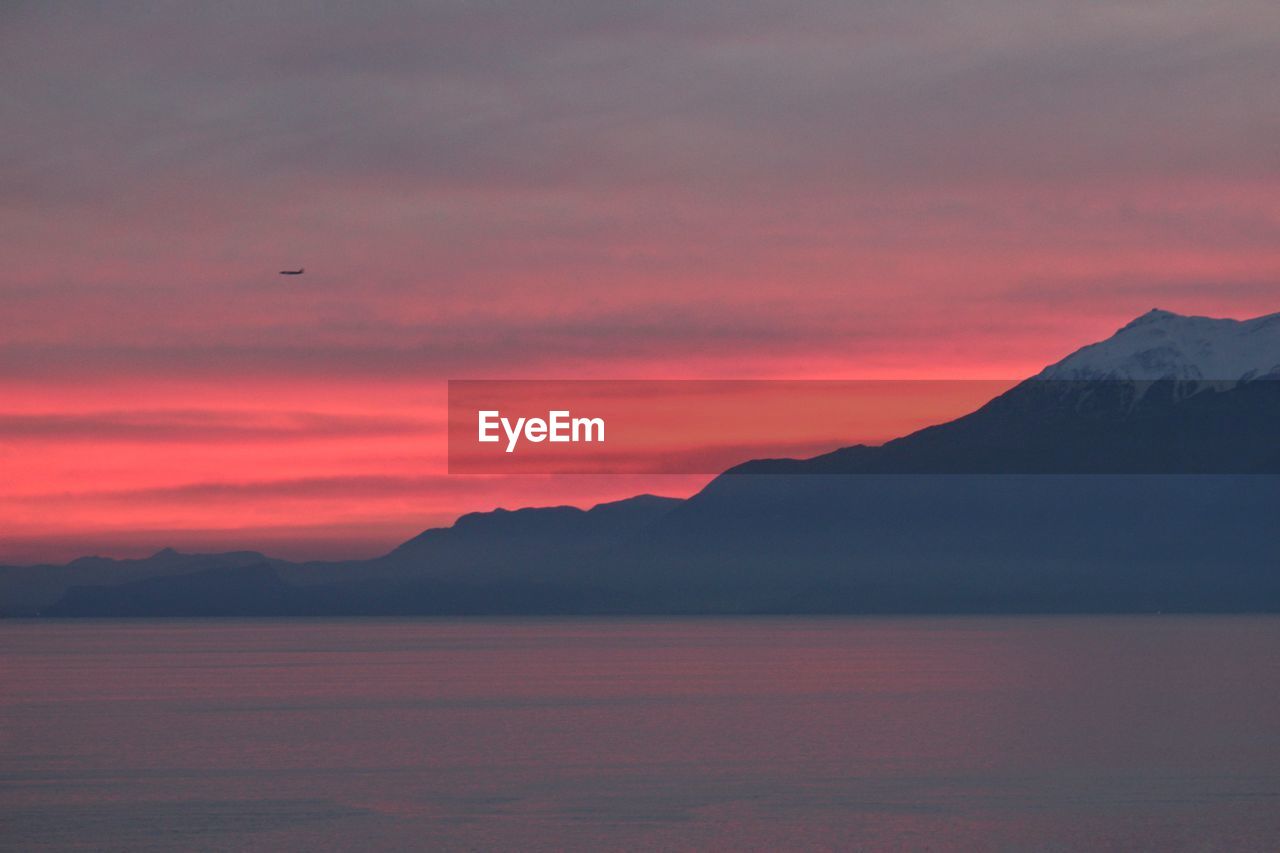 Scenic view of sea against orange sky