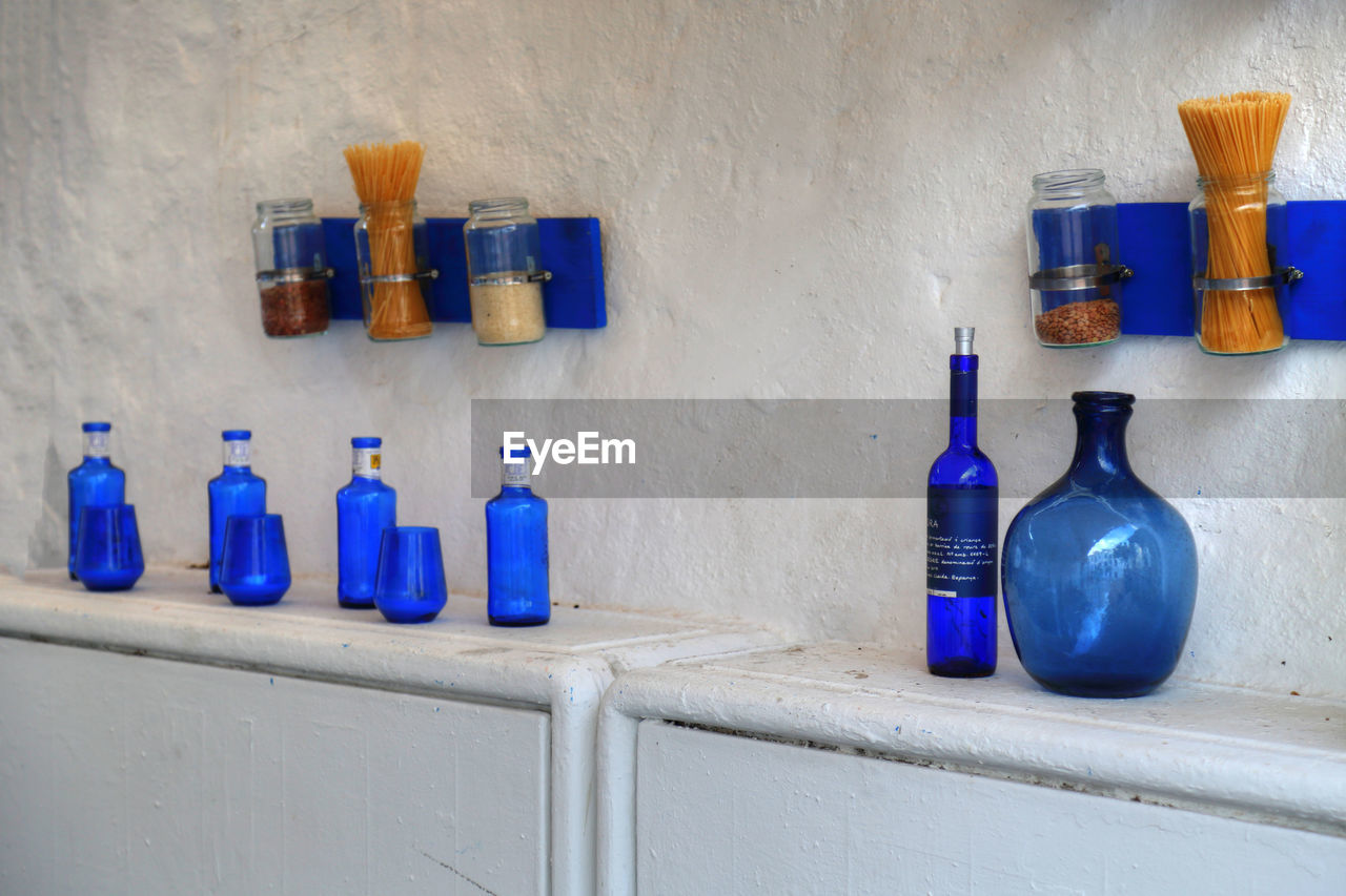 CLOSE-UP OF BOTTLES ON SHELF