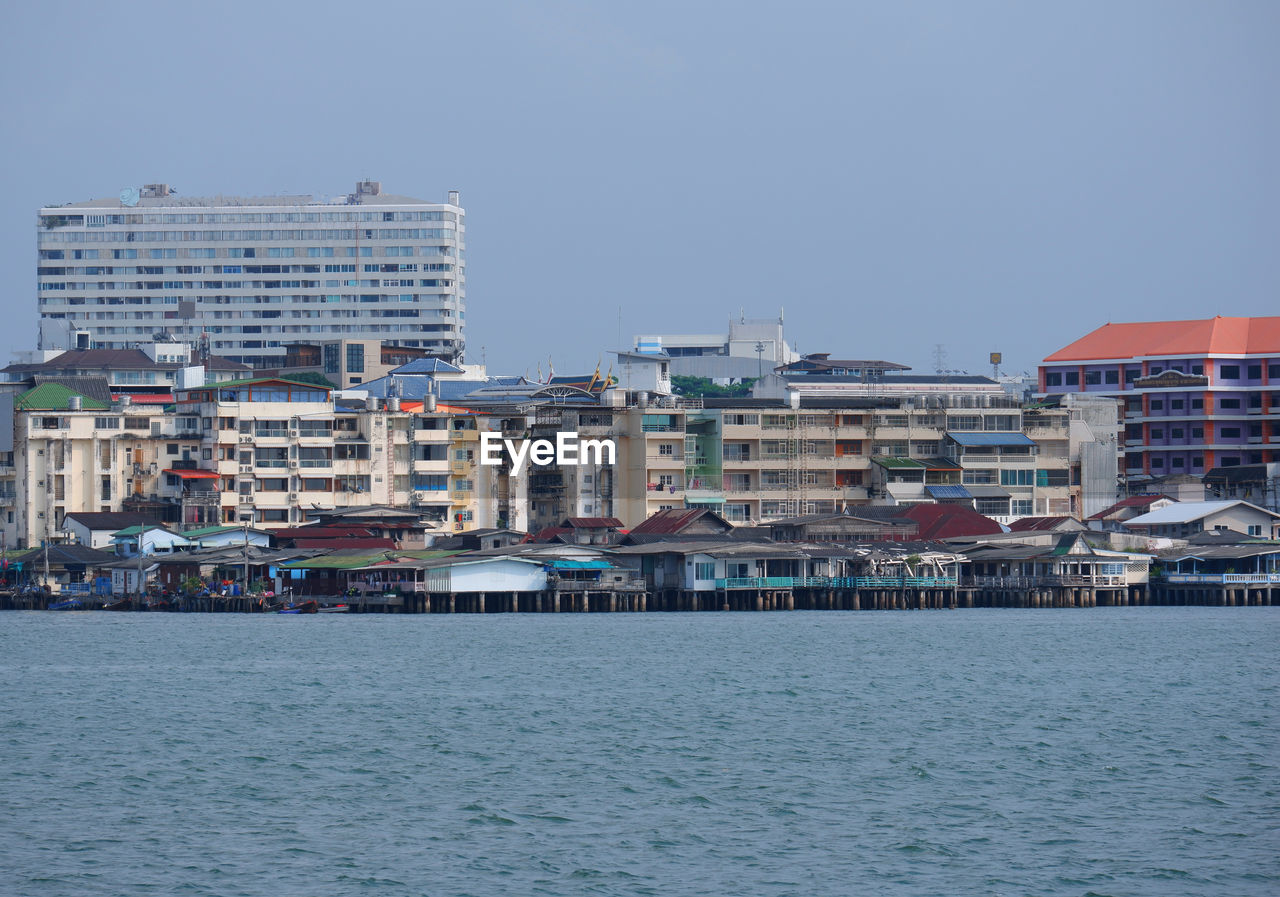 BUILDINGS BY SEA AGAINST SKY