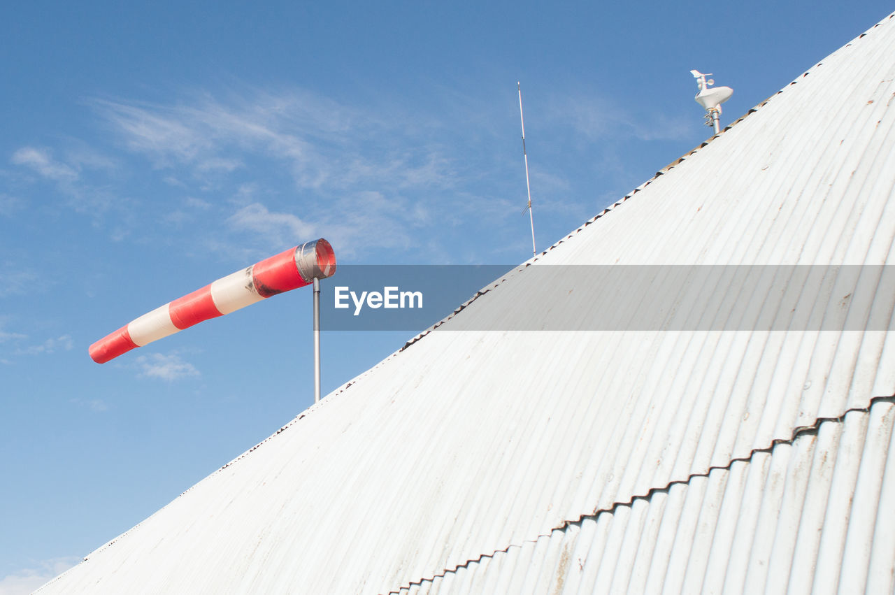 LOW ANGLE VIEW OF ROOF AGAINST WHITE SKY