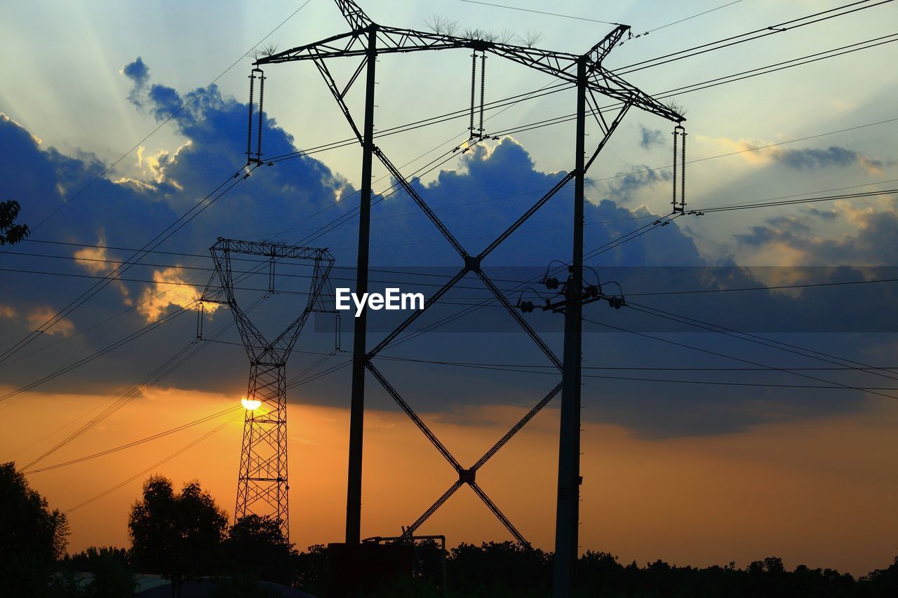 LOW ANGLE VIEW OF ELECTRICITY PYLON AGAINST SKY DURING SUNSET