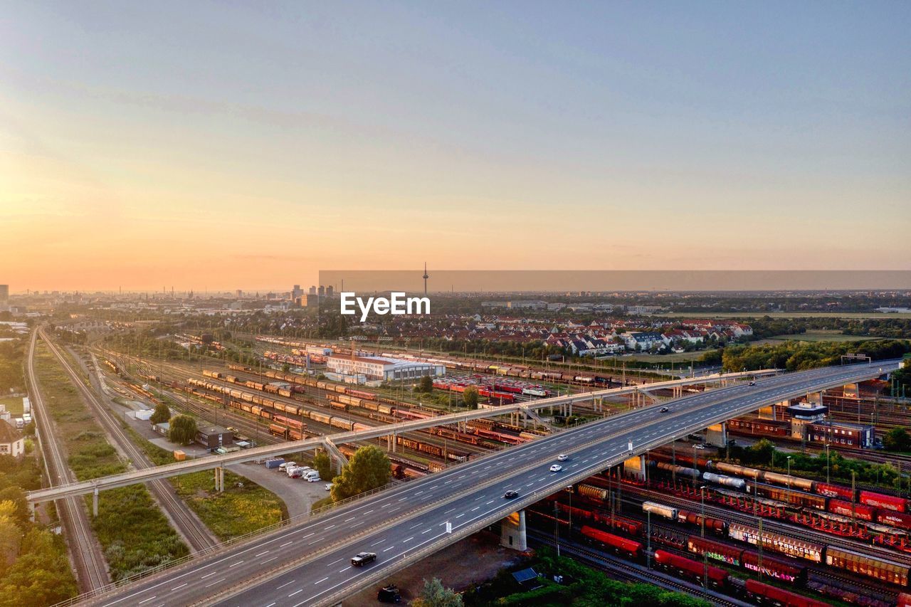 HIGH ANGLE VIEW OF TRAFFIC ON ROAD AT SUNSET