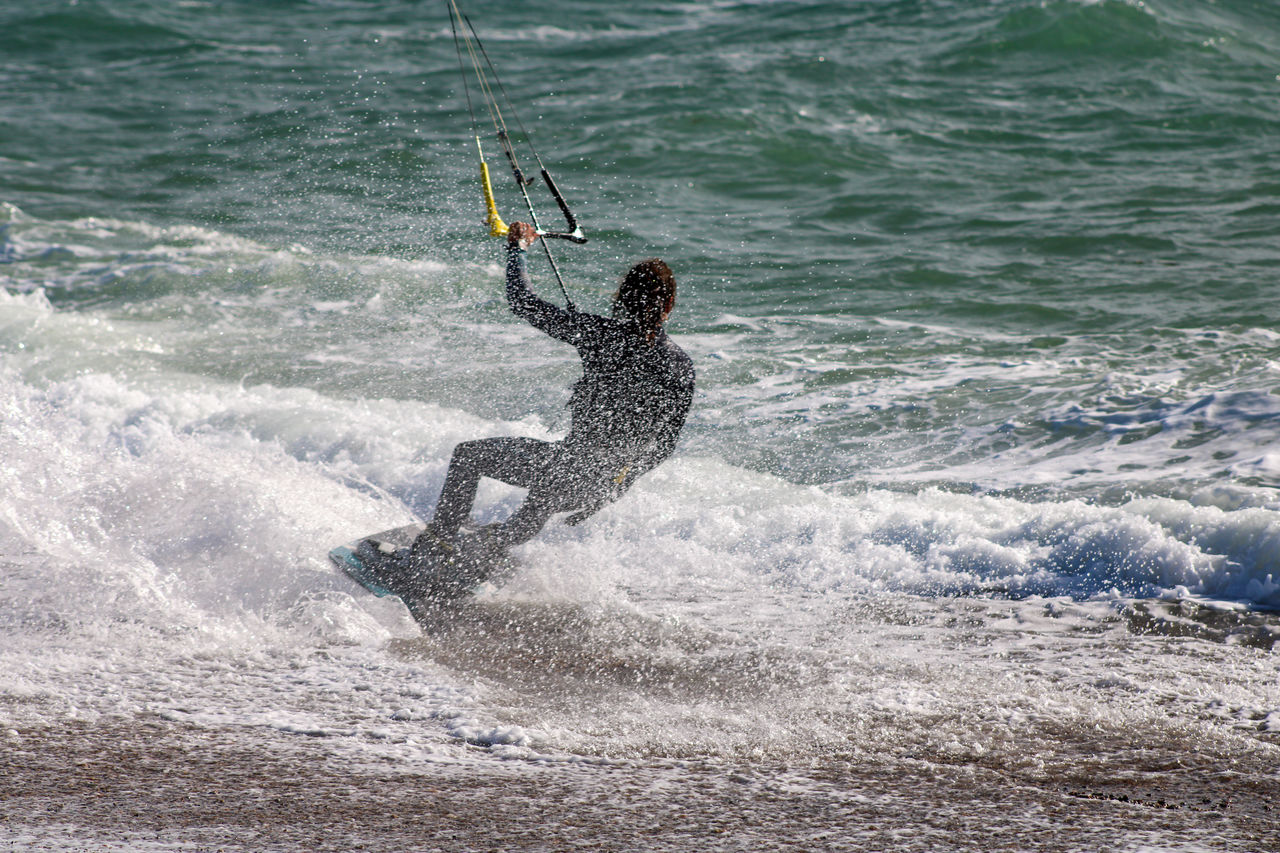 MAN SURFING ON SEA