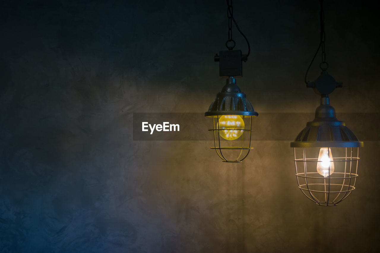 Hanging lamp, loft style bare plaster background.