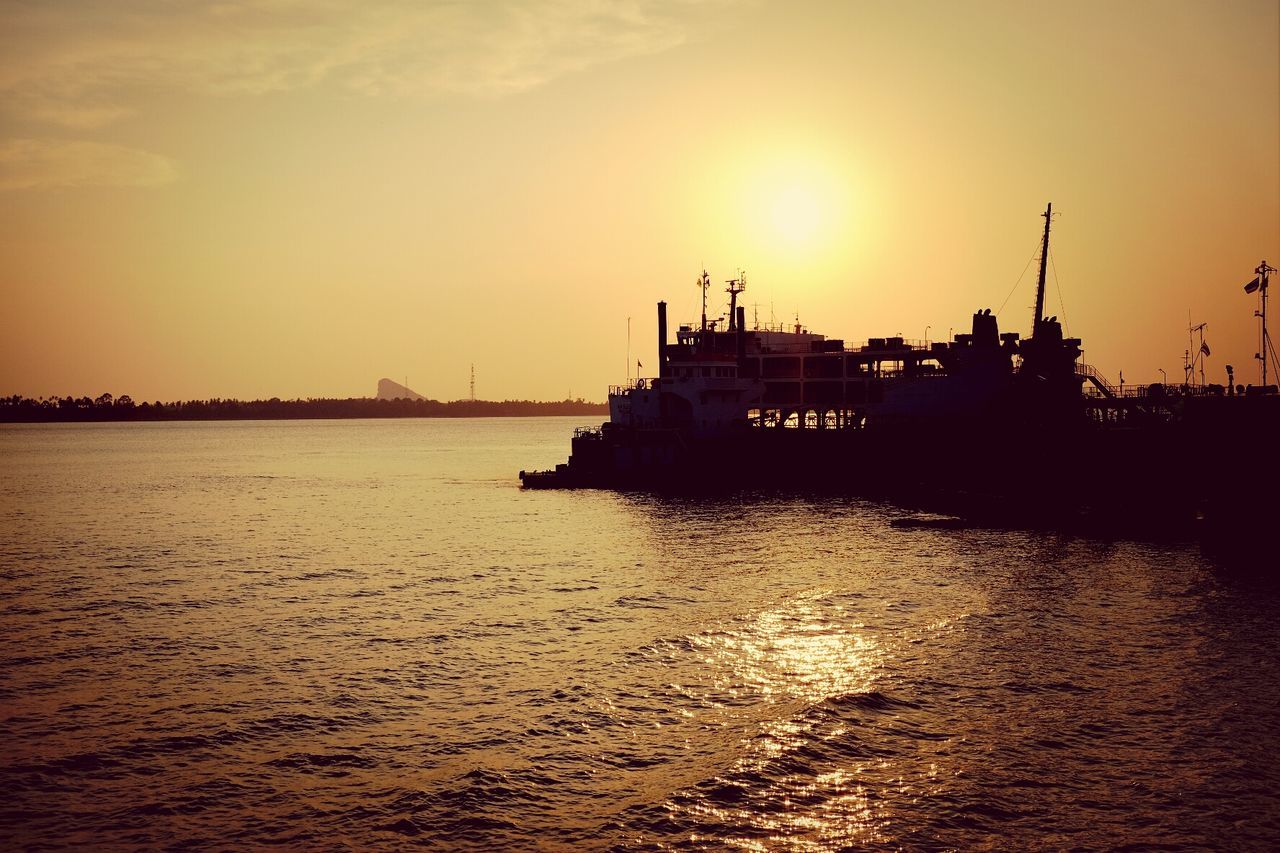 Ferry boat in sea at sunset