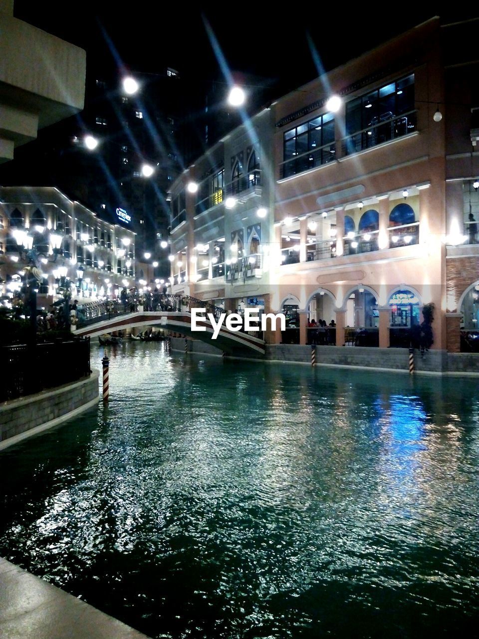 VIEW OF BRIDGE OVER RIVER AT NIGHT