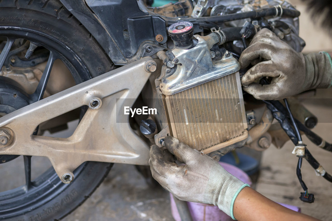 CLOSE-UP OF HANDS WORKING IN CAR