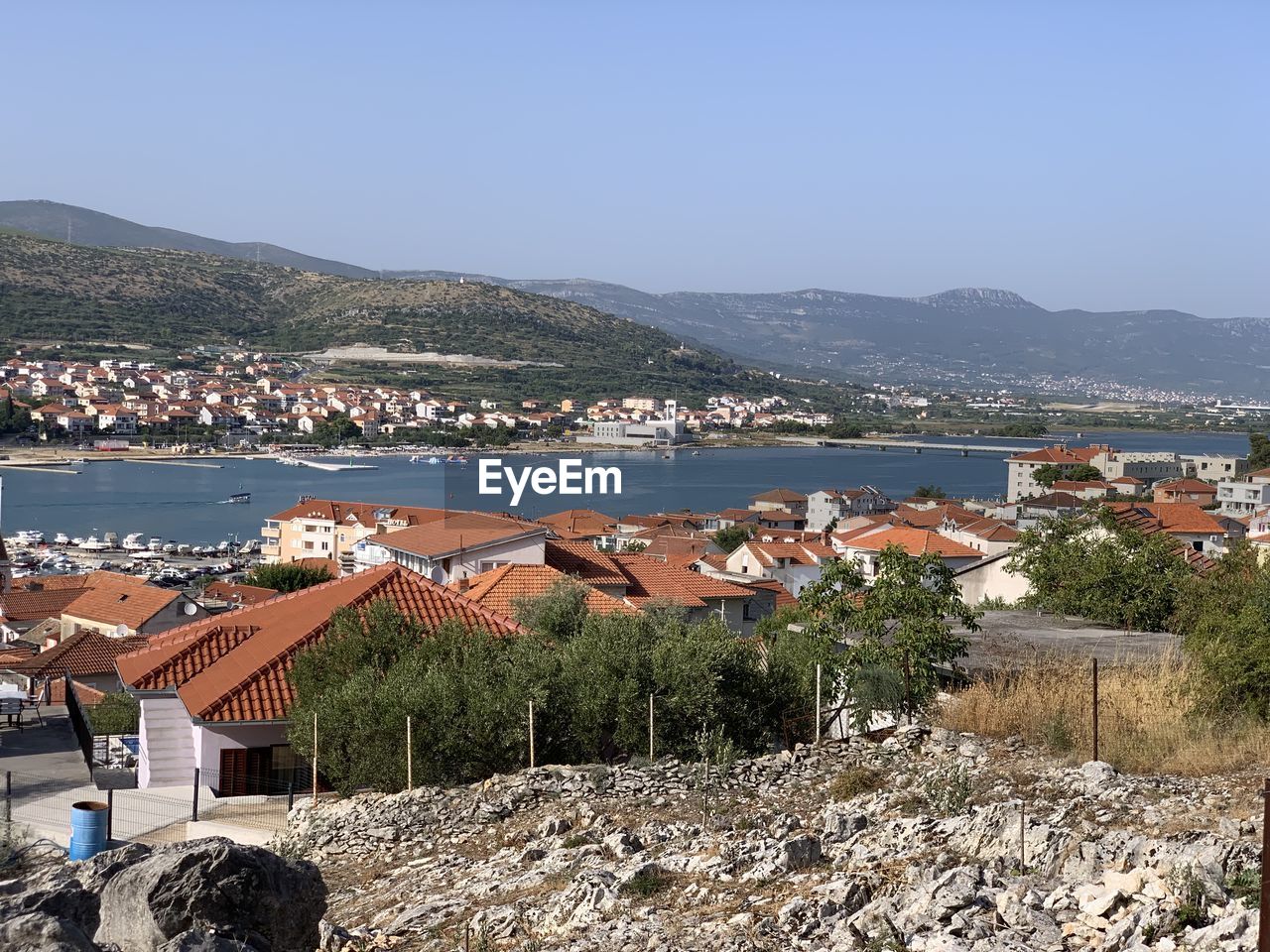 High angle view of townscape by sea against sky