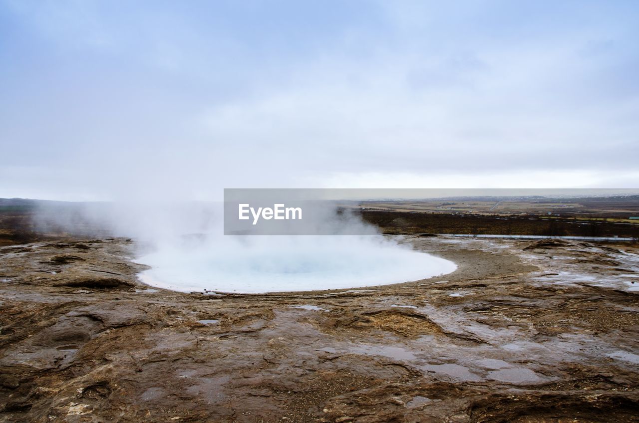 SCENIC VIEW OF CLOUDS OVER LANDSCAPE