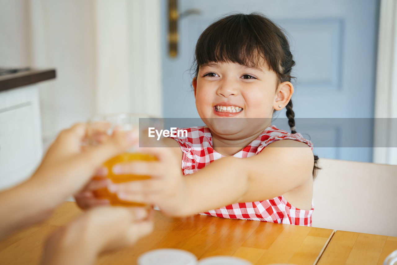 Portrait of happy boy at table at home