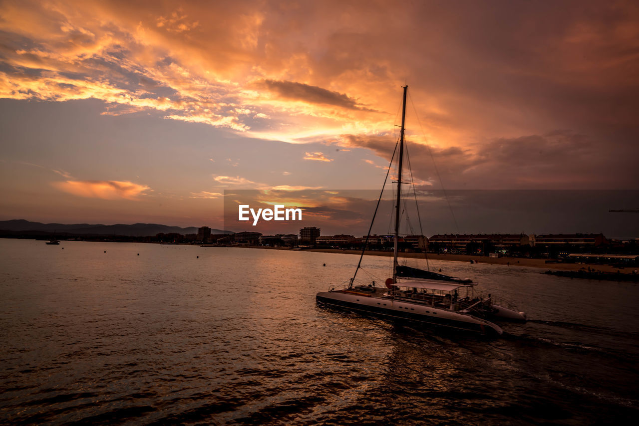 Sailboat in sea during sunset