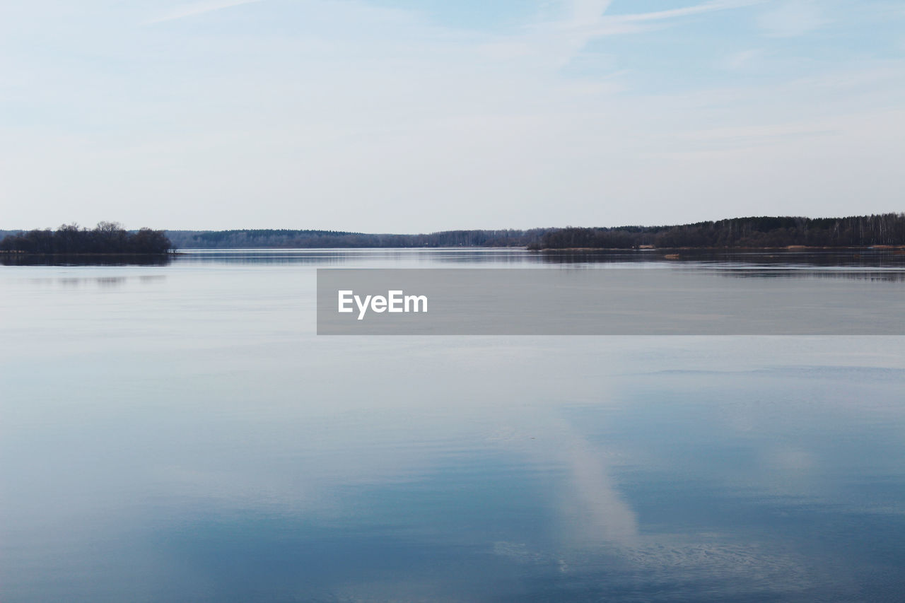 Scenic view of lake against sky during winter