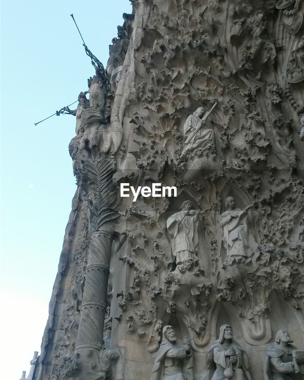 Low angle view of statue and carvings on sagrada familia