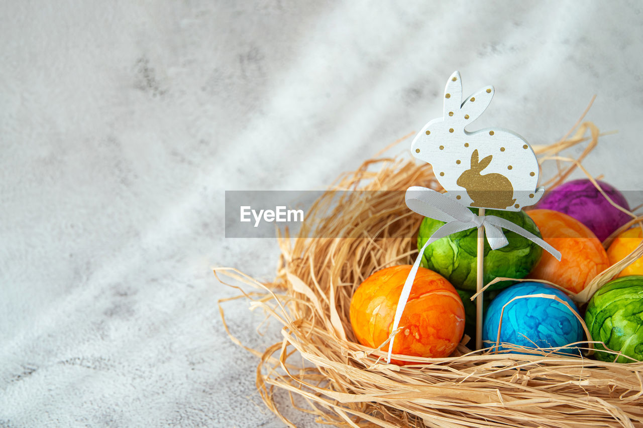 egg, easter, easter egg, tradition, food, multi colored, celebration, holiday, food and drink, no people, basket, nature, still life, container, animal nest, animal egg, high angle view, decoration, indoors, plant, freshness, close-up, creativity, religion, copy space