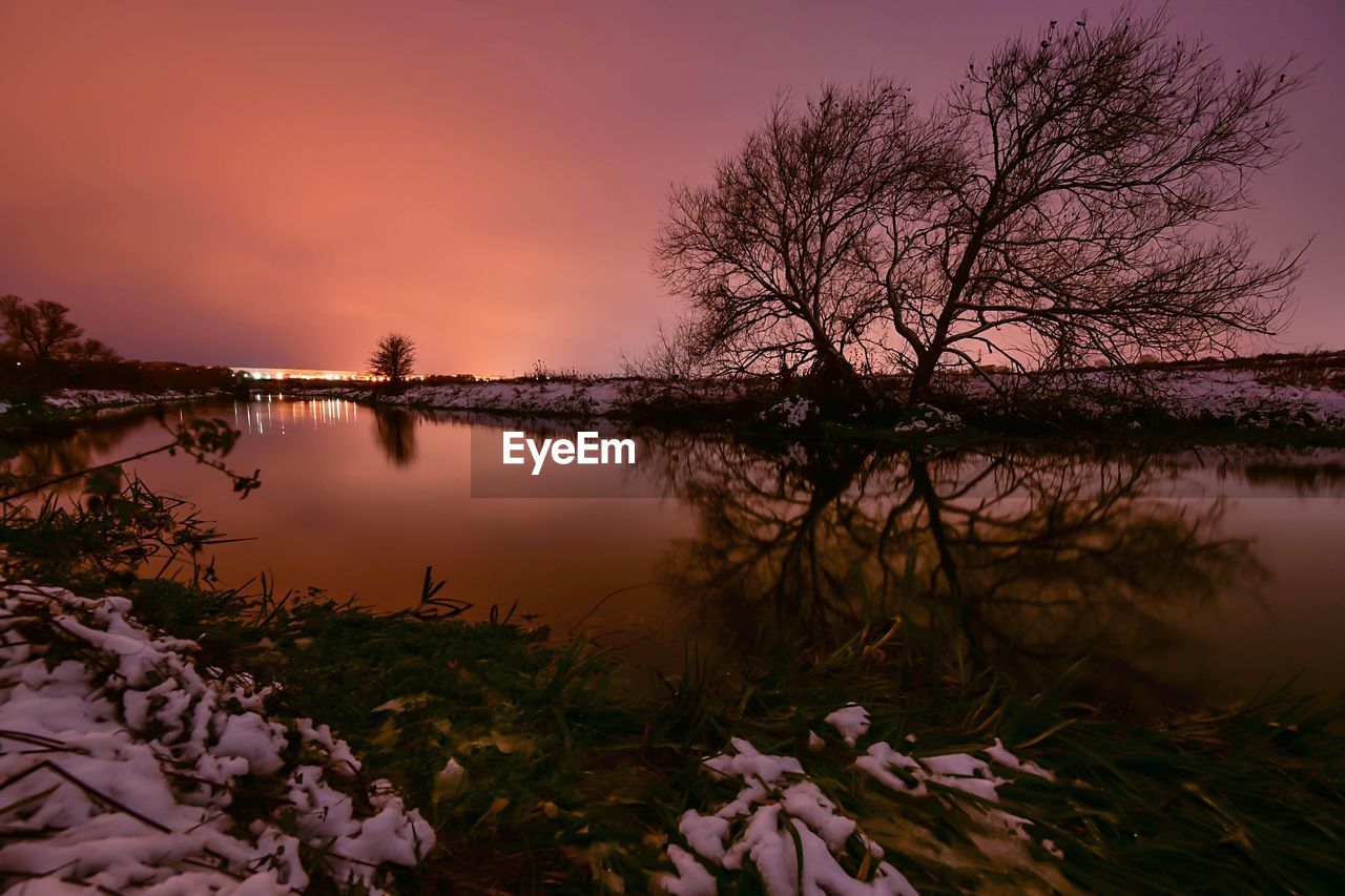 Scenic view of lake against sky during sunset