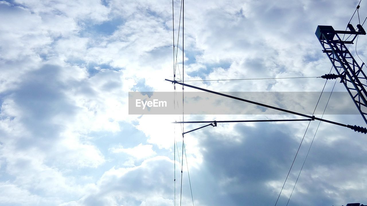 LOW ANGLE VIEW OF POWER LINES AGAINST CLOUDY SKY