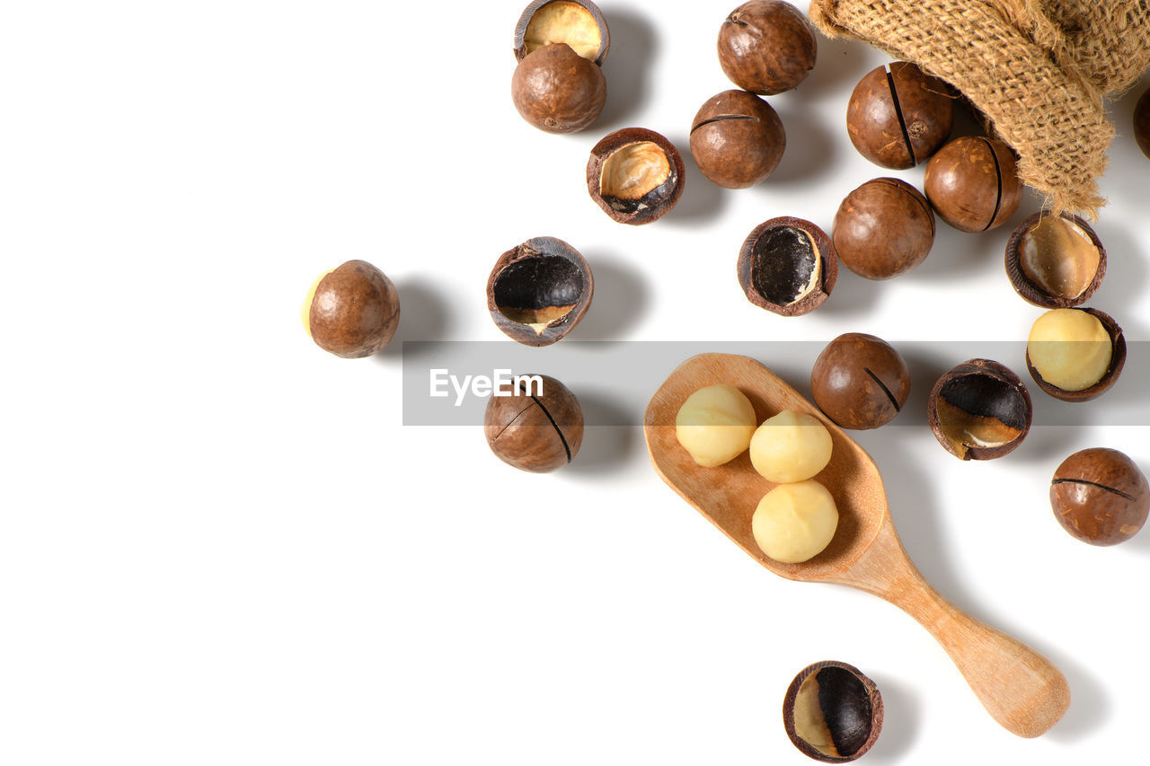 HIGH ANGLE VIEW OF COFFEE BEANS ON WHITE BACKGROUND