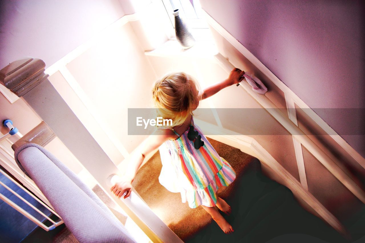 High angle view of girl on staircase at home