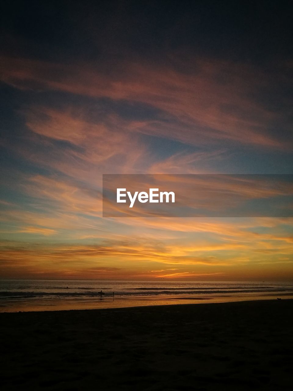 SCENIC VIEW OF BEACH AT SUNSET