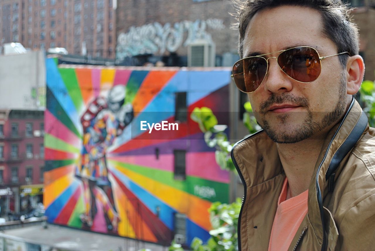 Portrait of man wearing sunglasses in city