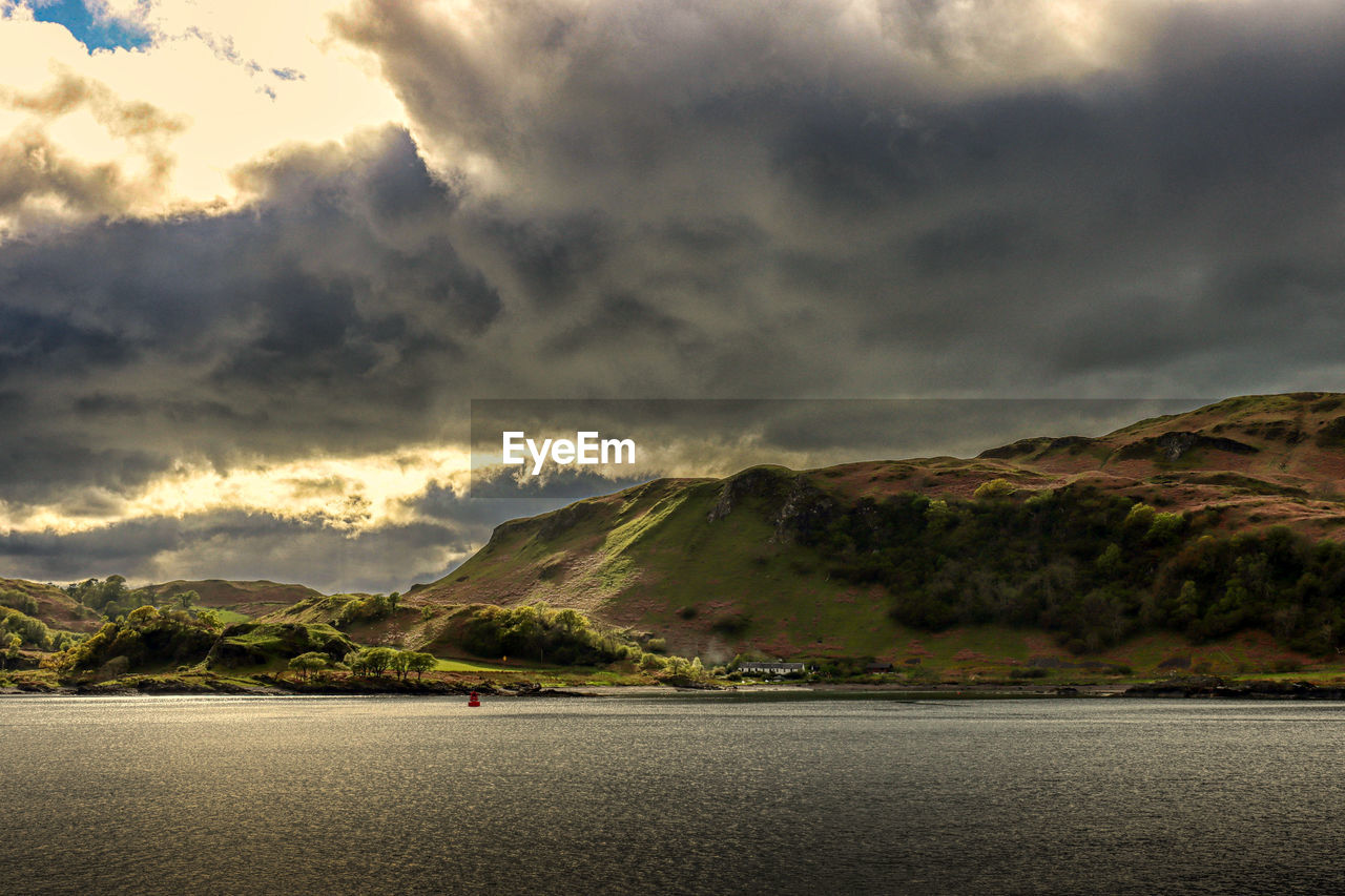 Scenic view of sea and mountains against sky. kerrera island, oban.