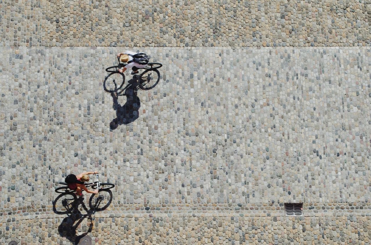 High angle view of people cycling on street
