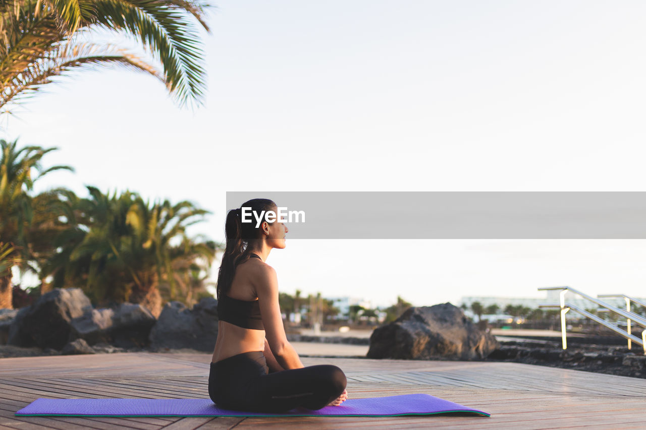 Young beautiful woman meditating outdoors.