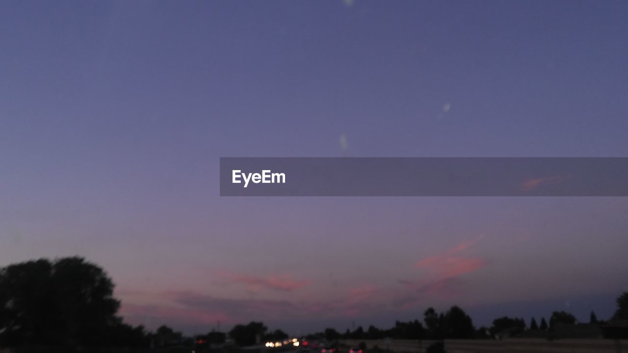 SILHOUETTE TREES AGAINST SKY AT DUSK